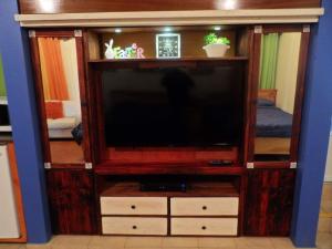 a large entertainment center with a flat screen tv at Family Guest House in Quebradillas