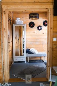 a small room with a bench and records on the wall at Leśne Zacisze Radawa I in Radawa