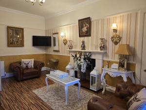 a living room with a couch and a fireplace at The Old Tramhouse Self Catering Traditional Charming Apartments Located In The Heart Of Historic Stirling For Short-Long Stays In Stirling For Tourism & Events & Contractor Base Stays For Central Belt Area & Open To Book All Year Round in Stirling