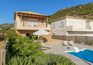 a villa with a swimming pool and a house at Seaside Aqua Bliss & Serenity with Private Pool in Kranidi