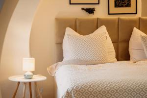 a bedroom with a bed and a table with a lamp at Brána historic Boutique Apartments in Horažďovice