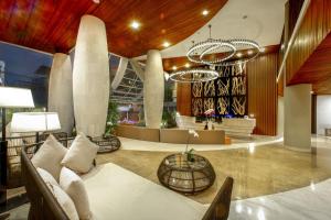 a lobby of a hotel with a couch and a table at Bedrock Hotel Kuta in Kuta