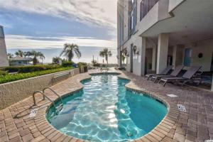 a swimming pool in front of a building at Compass Cove 1466 in Myrtle Beach