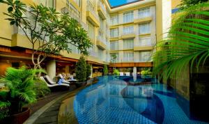a swimming pool in the middle of a building at Bedrock Hotel Kuta in Kuta +33 photos