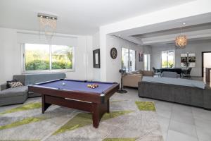 a living room with a pool table in it at Akefalou Bay Villa in Protaras