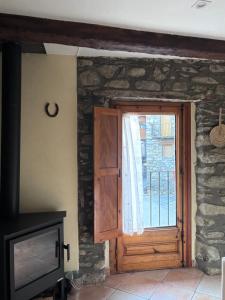 a wooden door in a room with a window at Apartament Cal Barracaire in Vilallonga de Ter +28 photos