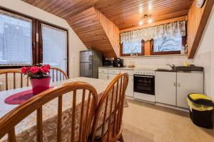 a kitchen with a table and chairs in a room at Apartma Horvat in Bohinj