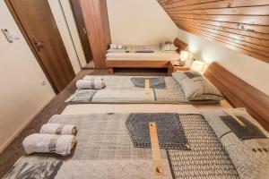 a room with three beds in a room at Apartma Horvat in Bohinj
