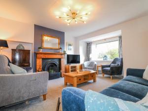 a living room with couches and a fireplace at Scamnel in Stafford