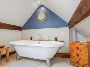 a bathroom with a white tub and a blue ceiling at Scamnel in Stafford +31 photos