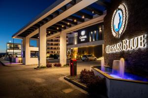 a building with a sign that reads cesar blacco at Gloria Apartments in Caesar Blue Resort,Gym, Swimming Pools, Sauna, Hammam, Kids' club available in Perivolia tou Trikomou