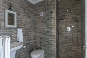 a bathroom with a toilet and a glass shower at Knysna Waterfront, Stunning Views in Knysna +30 photos