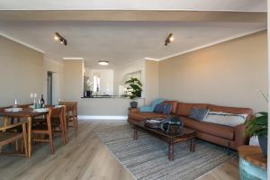 a living room with a couch and a table at Knysna Waterfront, Stunning Views in Knysna