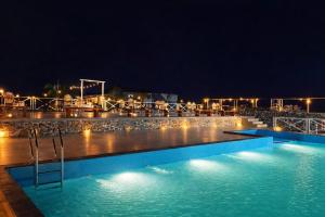 a swimming pool at night with lights at Sierra Vista Resort in Nashik