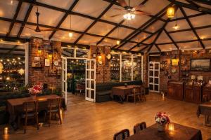 a restaurant with tables and chairs in a room at Sierra Vista Resort in Nashik