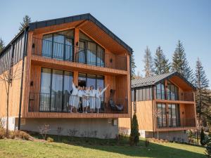a group of people standing on the balcony of a house at Phoenix Relax Park in Bukovel
