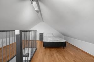 a small bedroom with a bed in a attic at Northstay - Skansegata Apartments, Apartment C l One-Bedroom in Tromsø