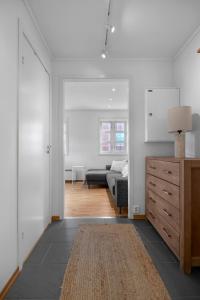 a white room with a bed and a dresser at Northstay - Skansegata Apartments, Apartment C l One-Bedroom in Tromsø