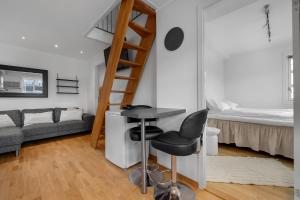 a small room with a bed and a desk and a chair at Northstay - Skansegata Apartments, Apartment C l One-Bedroom in Tromsø +9 photos
