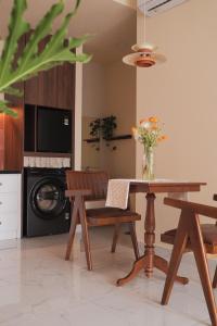 a kitchen with a table and chairs and a microwave at Healing Home - Charm Ruby Apartment in Dĩ An