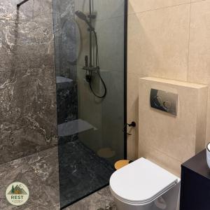 a bathroom with a shower with a toilet in it at Rest in Yablunytsya