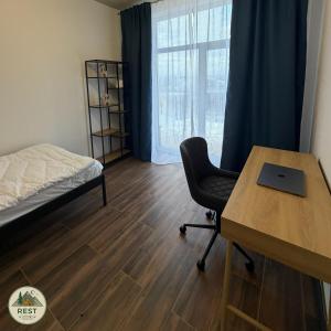 a bedroom with a desk and a bed and a desk chair at Rest in Yablunytsya