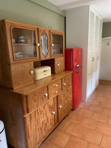 a kitchen with a wooden cabinet and a red refrigerator at Heidenest in Soltau +5 photos