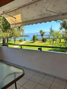a balcony with a table and a view of the water at Palmyra Beachfront Studios in Nydri