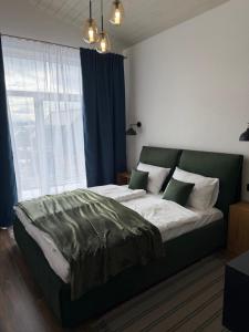 a bedroom with a large bed with a large window at Rest in Yablunytsya
