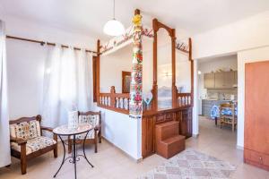 a living room with a table and a kitchen at Sofia Mike Houses in Olympos