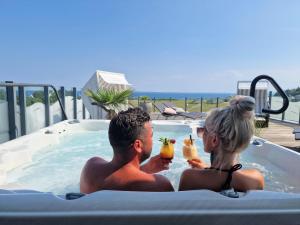 a man and a woman sitting in a hot tub at Ostseeferienpark Walkyrien in Schashagen
