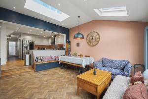 a living room with a table and a couch at Finest Retreats - Twickers Townhouse in Whitton