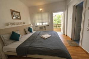a bedroom with a large bed and a window at Lilly candolim apartment in Candolim