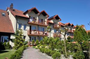 a building with a pathway in front of it at Kormoran Medispa in Rowy