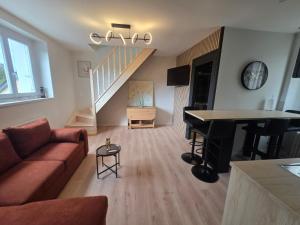 a living room with a couch and a table at L'aulne in Carhaix-Plouguer