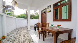 a dining room with a wooden table and chairs at Near Town Lodge in Dambulla +58 photos