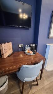a wooden desk with a coffee maker on top of it at The Clock Face Prescot in Prescot