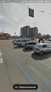 a group of cars parked in a parking lot at Apartment on Privokzalnaya 2/1 in Vinnytsya