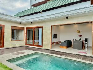 an indoor swimming pool in the backyard of a house at Moonlight Heaven Villa Ubud 2BR Private Pool in Tampaksiring
