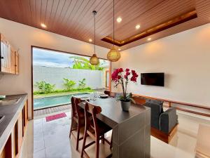 a kitchen and dining room with a table and chairs at Moonlight Heaven Villa Ubud 2BR Private Pool in Tampaksiring