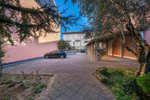 a car parked in a parking lot next to a building at Residence in Villa Giulia in Grado