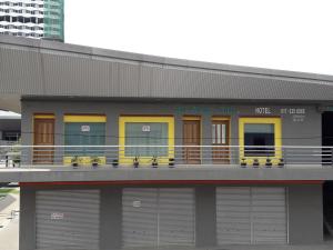 a building with four garage doors and a balcony at De Benz Inn in Malacca