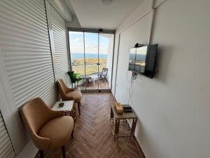 a room with two chairs and a flat screen tv at Sheraton Palace Sea View in Alexandria