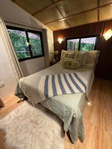 a bedroom with a bed with a pillow on it at Hangin at Agos Resort in Nasugbu