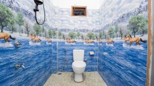 a bathroom with a painting of horses in the water at Near Town Lodge in Dambulla