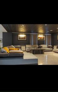 a room with several beds and couches in it at Ana Apartment at Orbi in Bakuriani