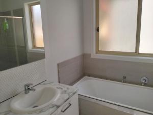 a bathroom with a sink and a bath tub at Comfort and good value in Melton South +9 photos
