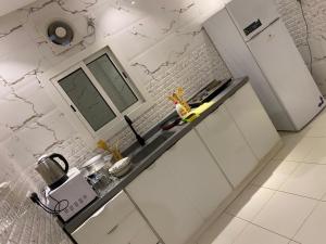 a kitchen with white cabinets and a counter top at المهيدب للوحدات السكنيه -رابغ in Rabigh