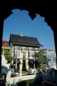 a large house with a black roof at Makkachiva in Chiang Mai