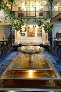 a lobby with a large fountain in the middle of a building at Makkachiva in Chiang Mai